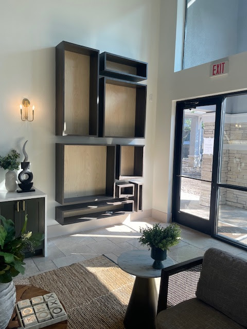 Modern interior design by PS Premier Construction featuring contemporary shelving and natural lighting
